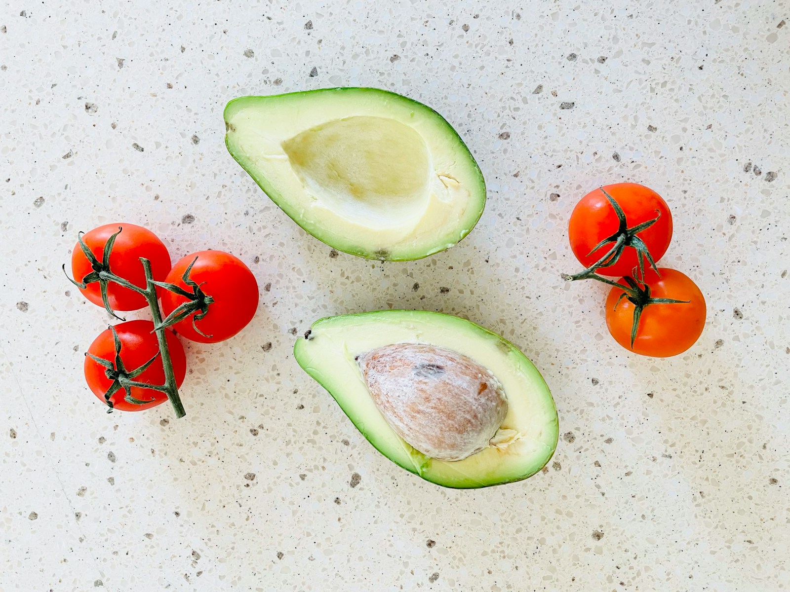 Avocado and tomatoes on a counter top