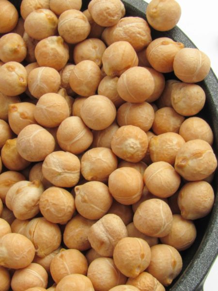 a bowl filled with chickpeas sitting on top of a table