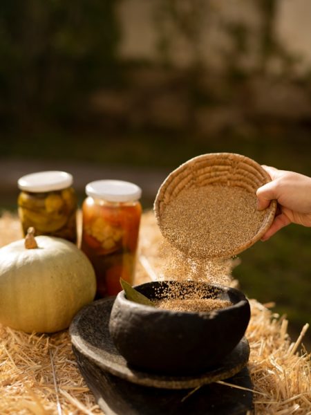 a hand holding a jar of food